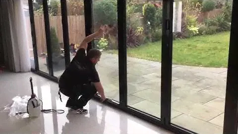 PR Solar Window Film Ltd applying one-way privacy window film to bi-folding doors